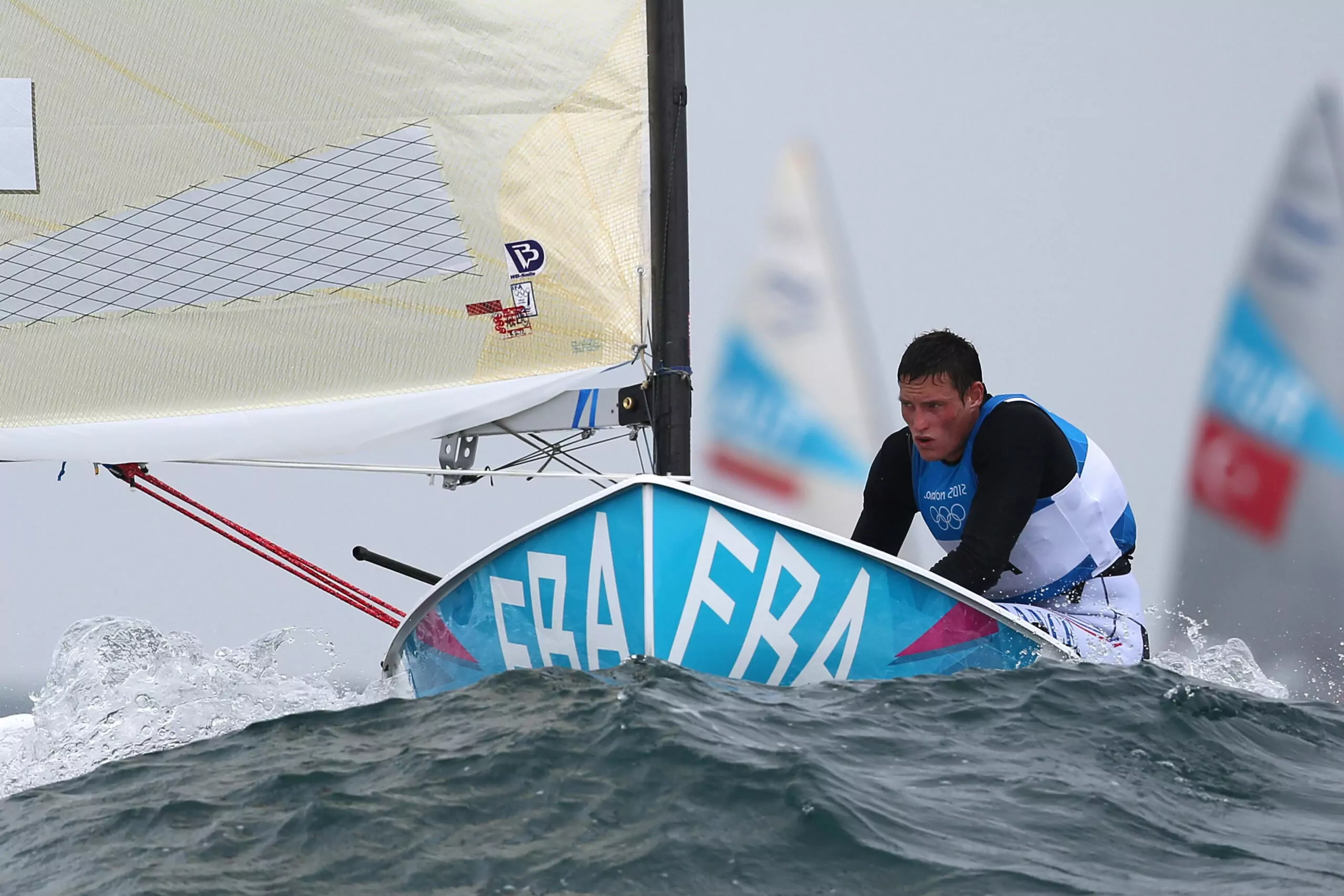 Jonathan Lobert competing in sailing at the London 2012 Olympics, symbolizing focus and high performance